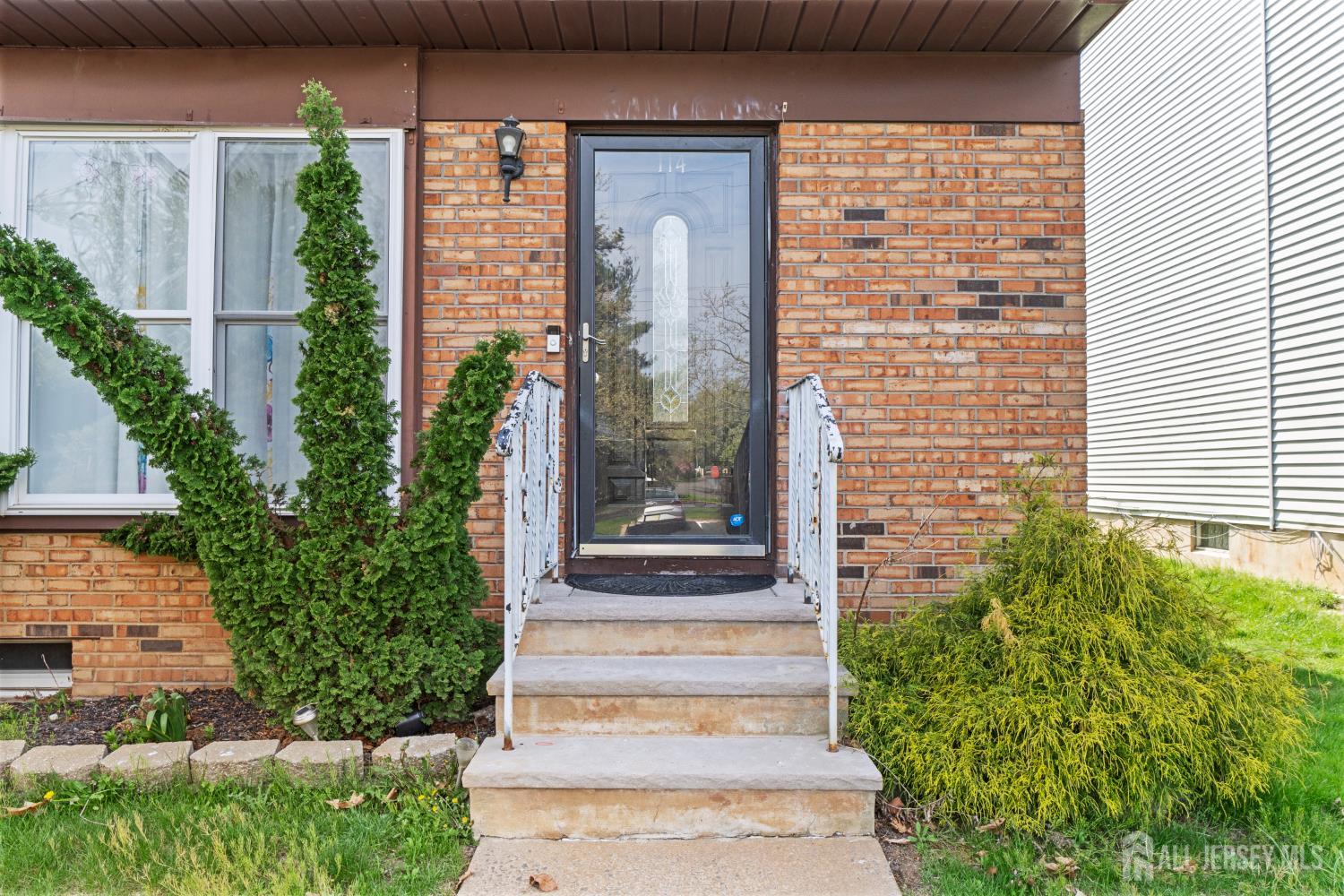 114 Pendleton Place Old Bridge, NJ 08857 - Photo 5 of 49 a front view of a house with a garden