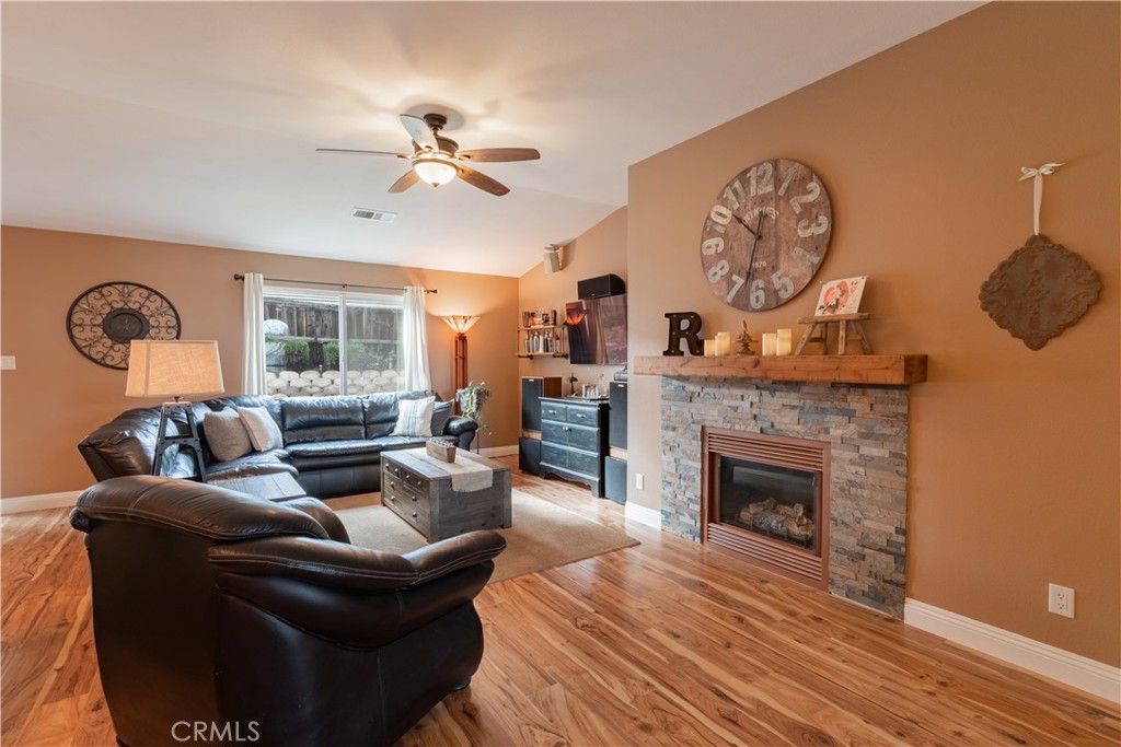2660 Vineyard Circle Paso Robles, CA 93446 - Photo 6 of 39 a living room with furniture a fireplace and a large window