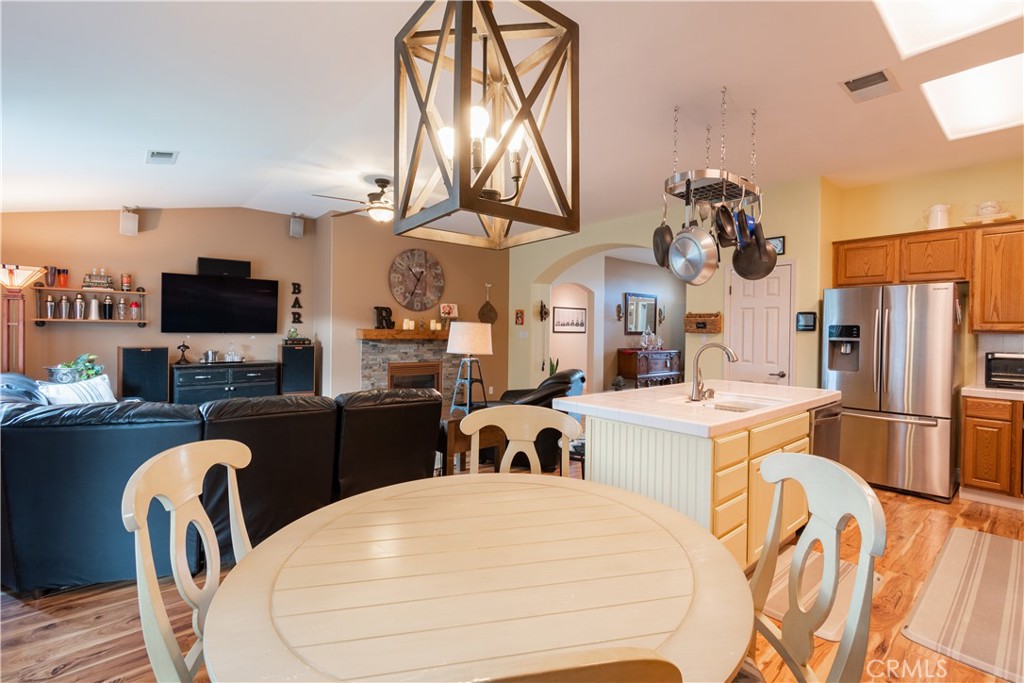 2660 Vineyard Circle Paso Robles, CA 93446 - Photo 8 of 39 a kitchen with stainless steel appliances kitchen island granite countertop a table chairs in it and a microwave