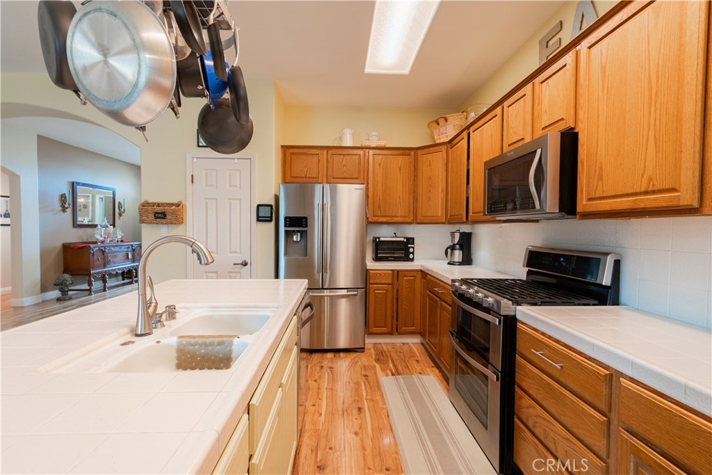 2660 Vineyard Circle Paso Robles, CA 93446 - Photo 9 of 39 a kitchen with stainless steel appliances granite countertop a sink a stove and a refrigerator