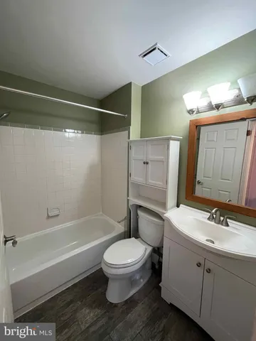 a bathroom with a toilet sink and shower