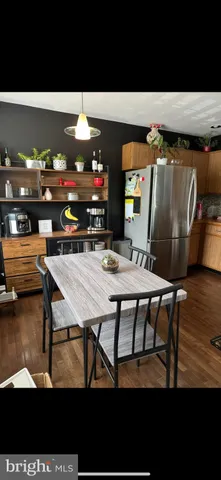 a dining room with furniture and wooden floor