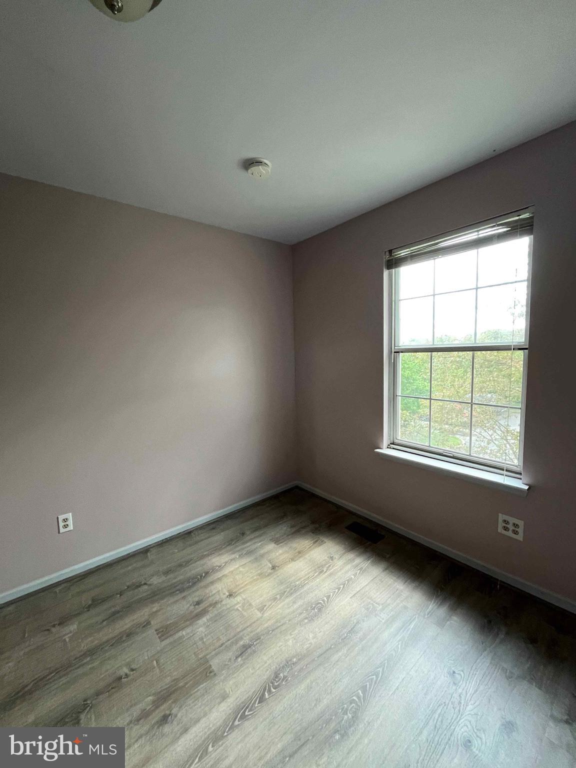 500 Crystal, Unit 19A Norristown, PA 19403 - Photo 9 of 11 an empty room with wooden floor and windows