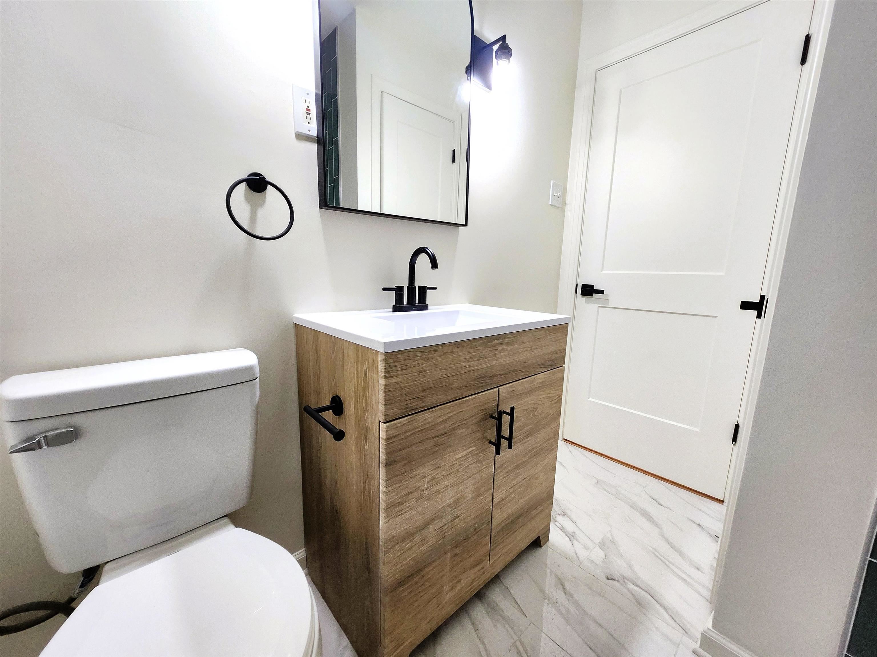 5030 Dee Road Memphis, TN 38117 - Photo 18 of 19 a bathroom with a toilet sink and mirror