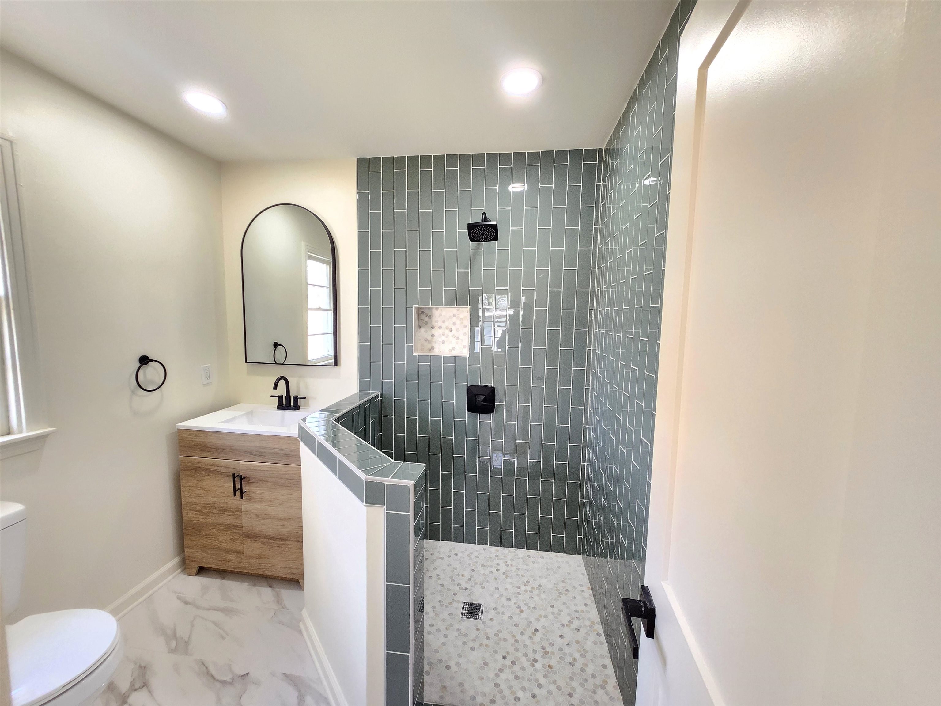 5030 Dee Road Memphis, TN 38117 - Photo 10 of 19 a bathroom with a sink a toilet and mirror