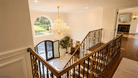 a view of entryway livingroom and hall with wooden floor