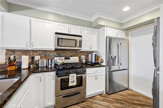 a kitchen with a refrigerator stove and microwave