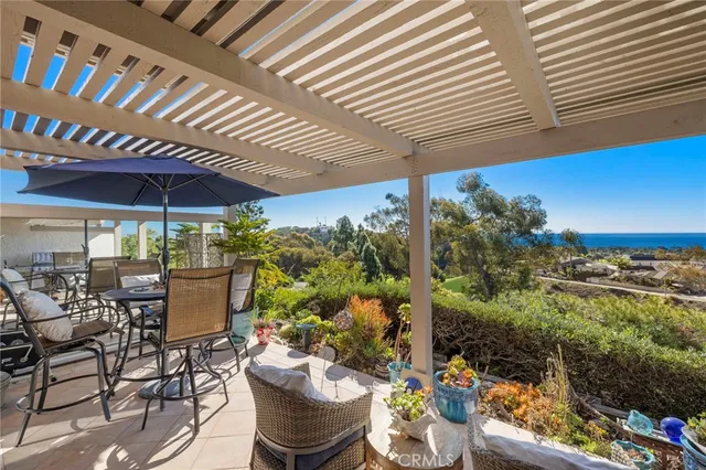 a view of a patio with table and chairs and potted plants