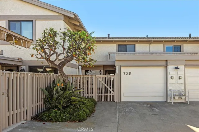 a front view of a house with plants