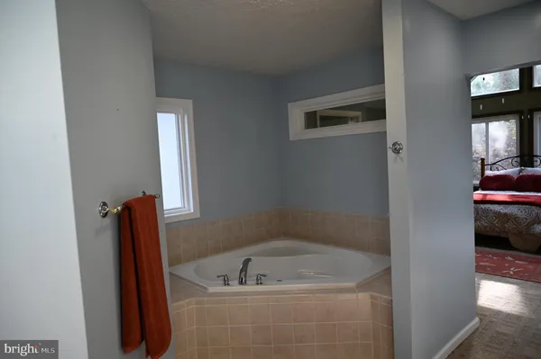 a bath tub sitting in a bathroom next to a sink