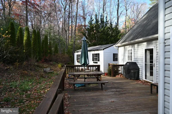 a view of a bench in the backyard