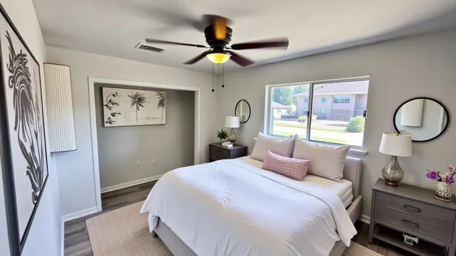a bedroom with a large bed and a chandelier