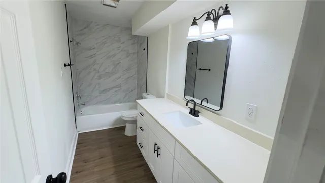 a bathroom with a double vanity sink mirror double and bathtub