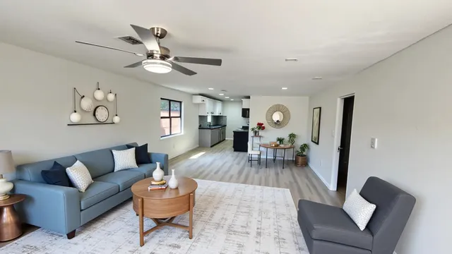 a living room with furniture and a wooden floor