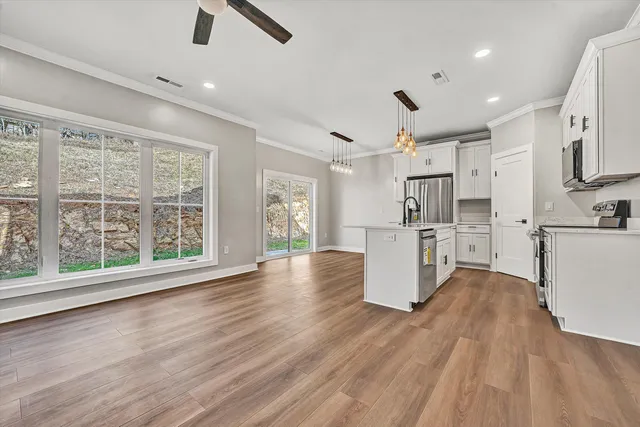a view of kitchen with furniture and wooden floor