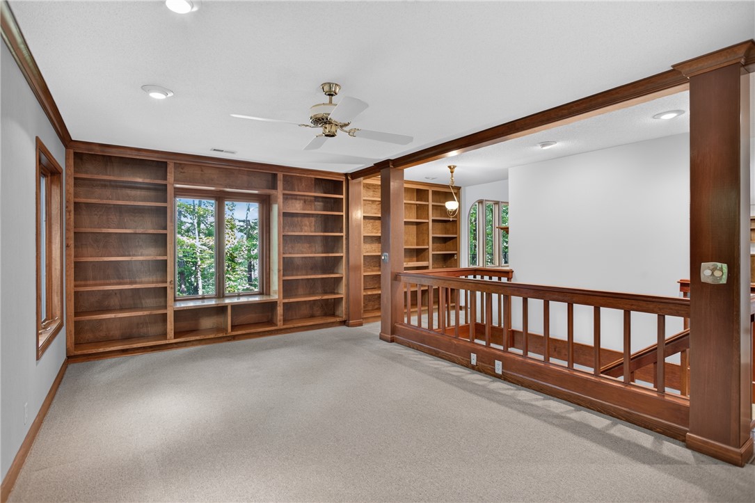 12 Lookout Lane Salem, SC 29676 - Photo 7 of 47 Custom built-in bookcases provide ample storage and display space in this inviting, sunlit area.
