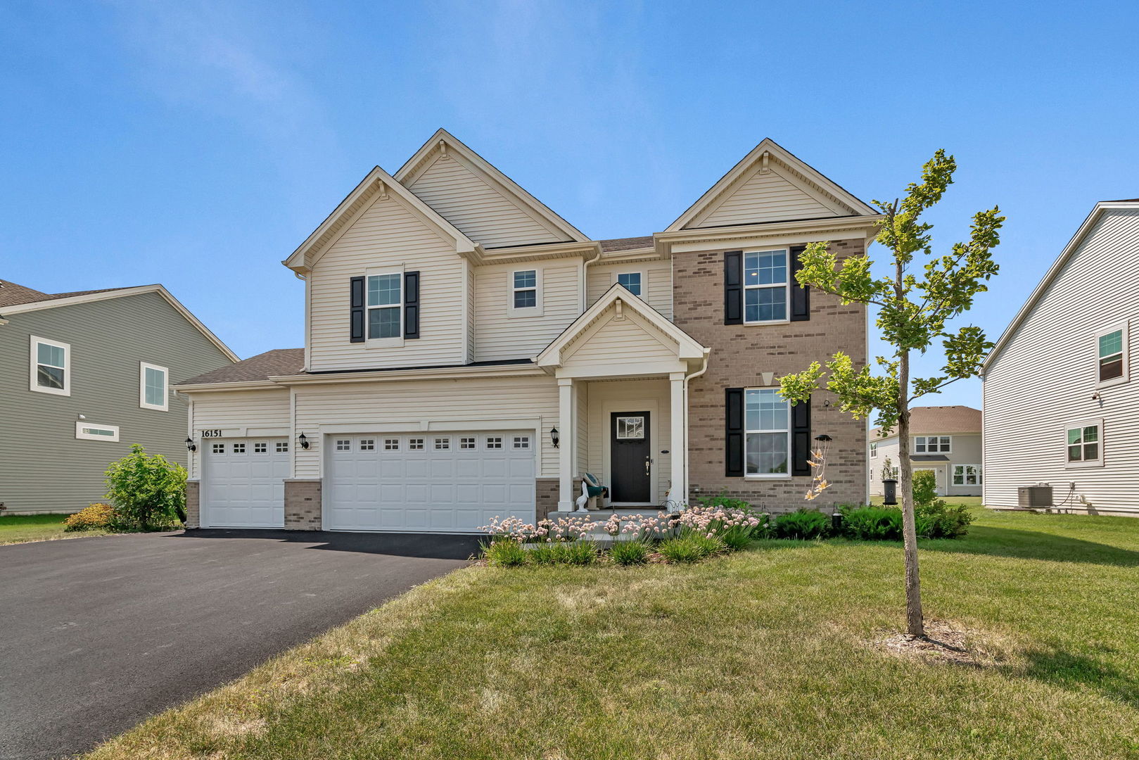 a front view of a house with a yard and garage