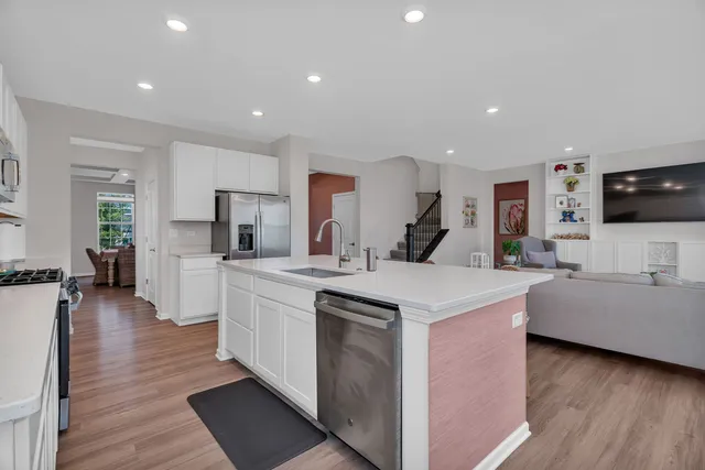 a large kitchen with cabinets and wooden floor
