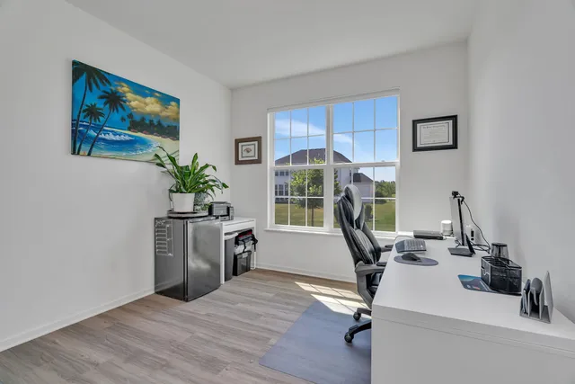a view of a workspace with furniture and a potted plant