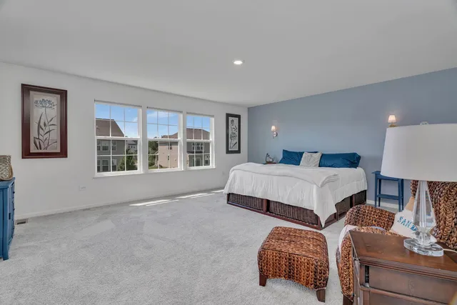 a bedroom with a bed and glass window