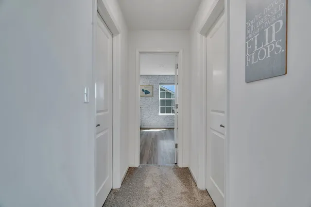 a view of a hallway with wooden shelves