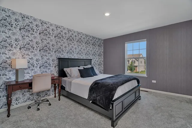 a spacious bedroom with a bed and a window