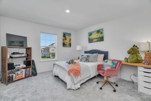 a bedroom with a bed and a chair in it