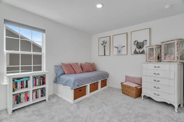 a living room with furniture and a book shelf