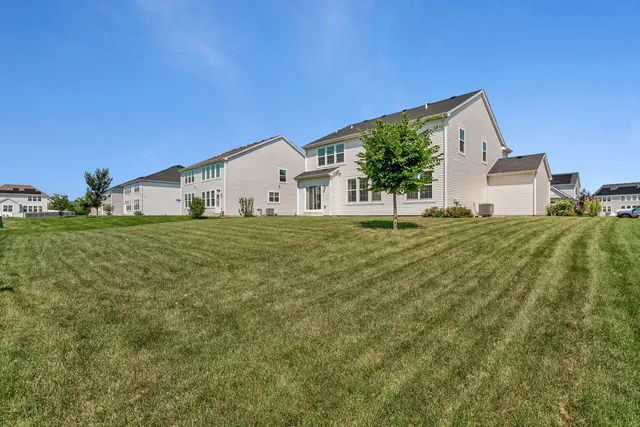 a big house with a big yard and large trees
