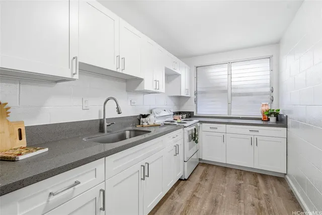 a kitchen with sink and cabinets