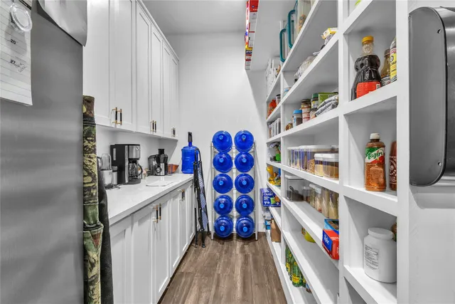 a large kitchen with a table and chairs in it