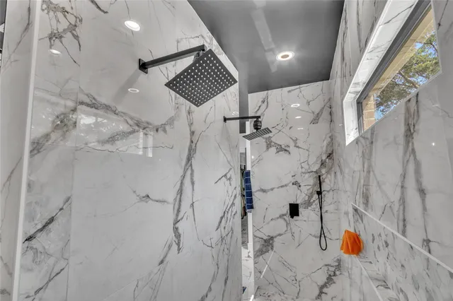 a bathroom with a sink a mirror and shower