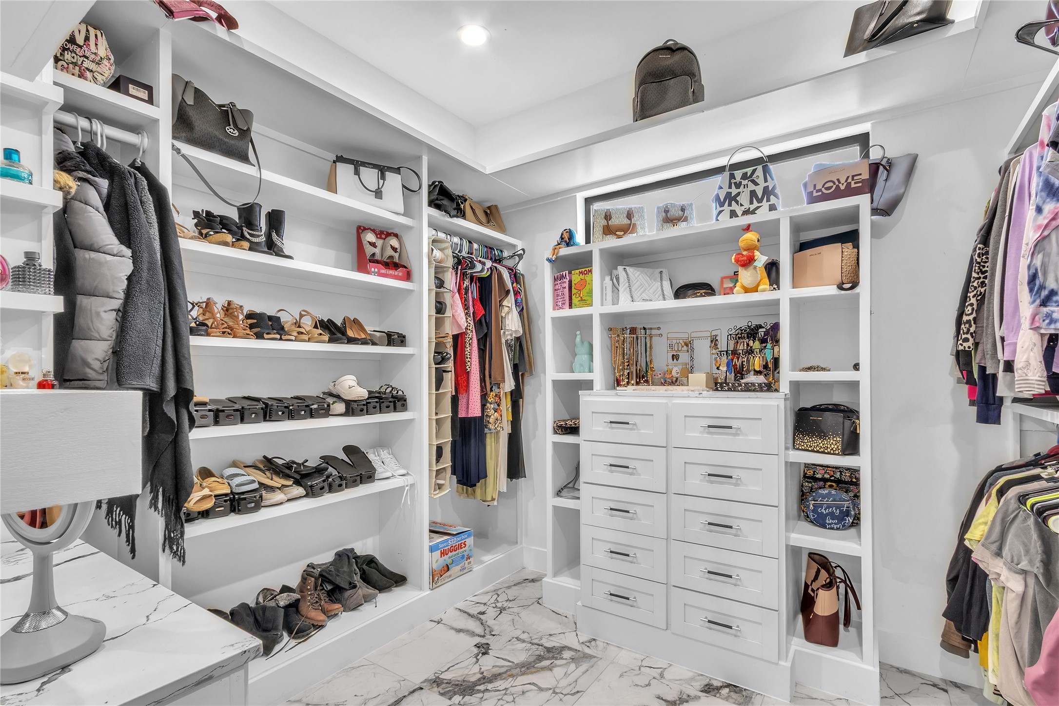 15406 Torry Pines Road Houston, TX 77062 - Photo 25 of 50 a view of walk in closet with clothes and shoes