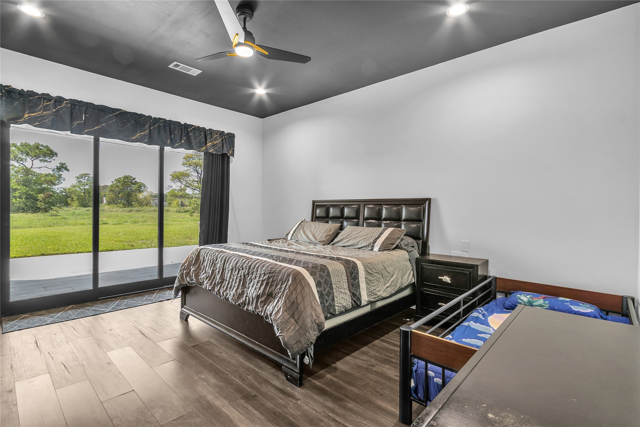 15406 Torry Pines Road Houston, TX 77062 - Photo 27 of 50 a bedroom with a bed and glass walk in closet