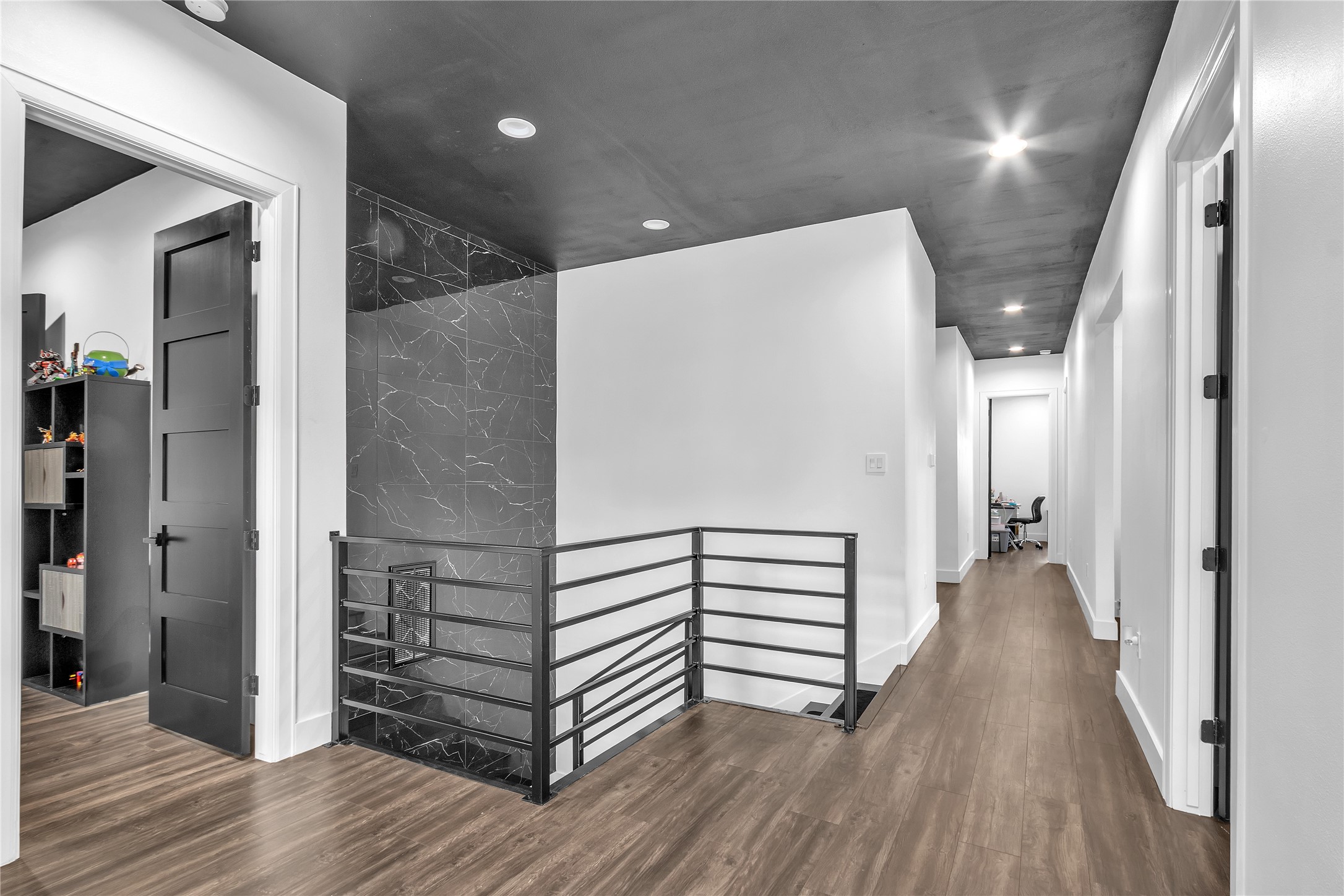 15406 Torry Pines Road Houston, TX 77062 - Photo 32 of 50 a view of a hallway with wooden floor and staircase