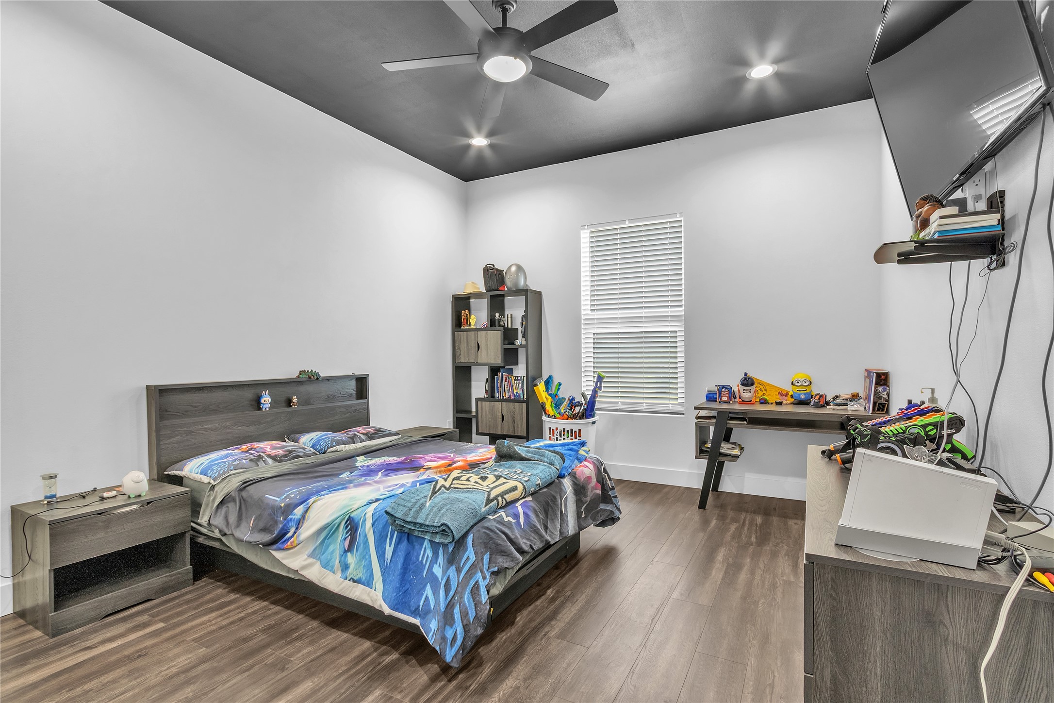 15406 Torry Pines Road Houston, TX 77062 - Photo 38 of 50 a bedroom with a bed and wooden floor