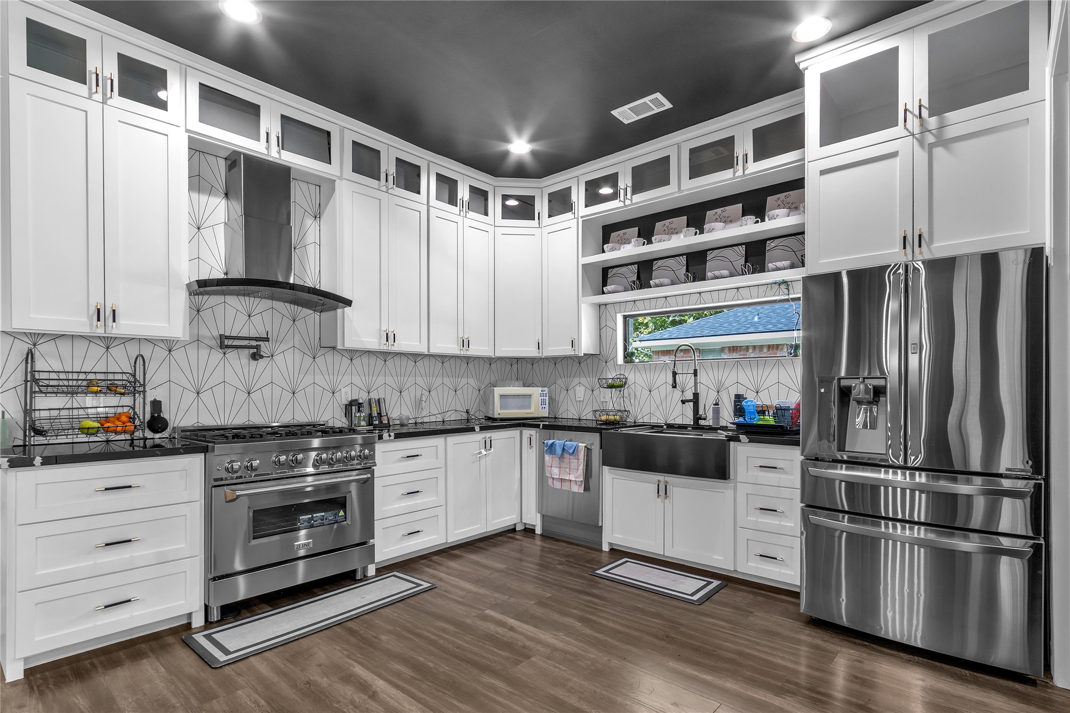 15406 Torry Pines Road Houston, TX 77062 - Photo 6 of 50 a kitchen with granite countertop a refrigerator and a stove top oven