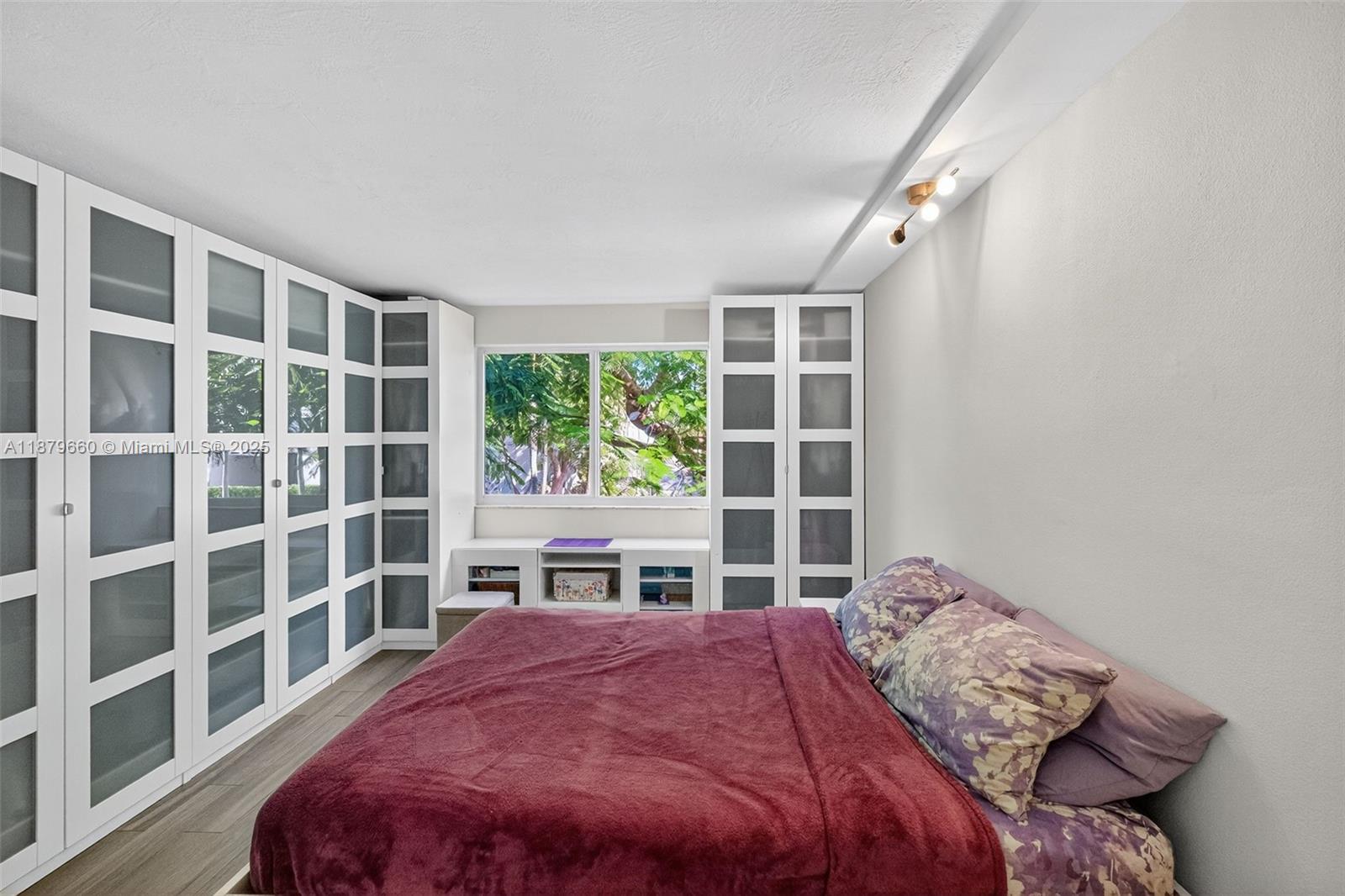 240 Galen Drive, Unit 207 Key Biscayne, FL 33149 - Photo 11 of 21 a bedroom with a bed and a window