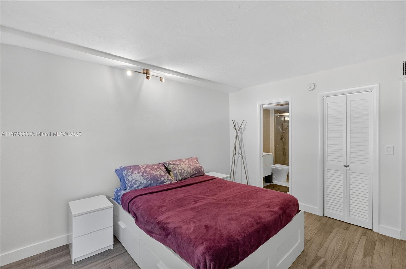 240 Galen Drive, Unit 207 Key Biscayne, FL 33149 - Photo 12 of 21 a bedroom with a bed and wooden floor