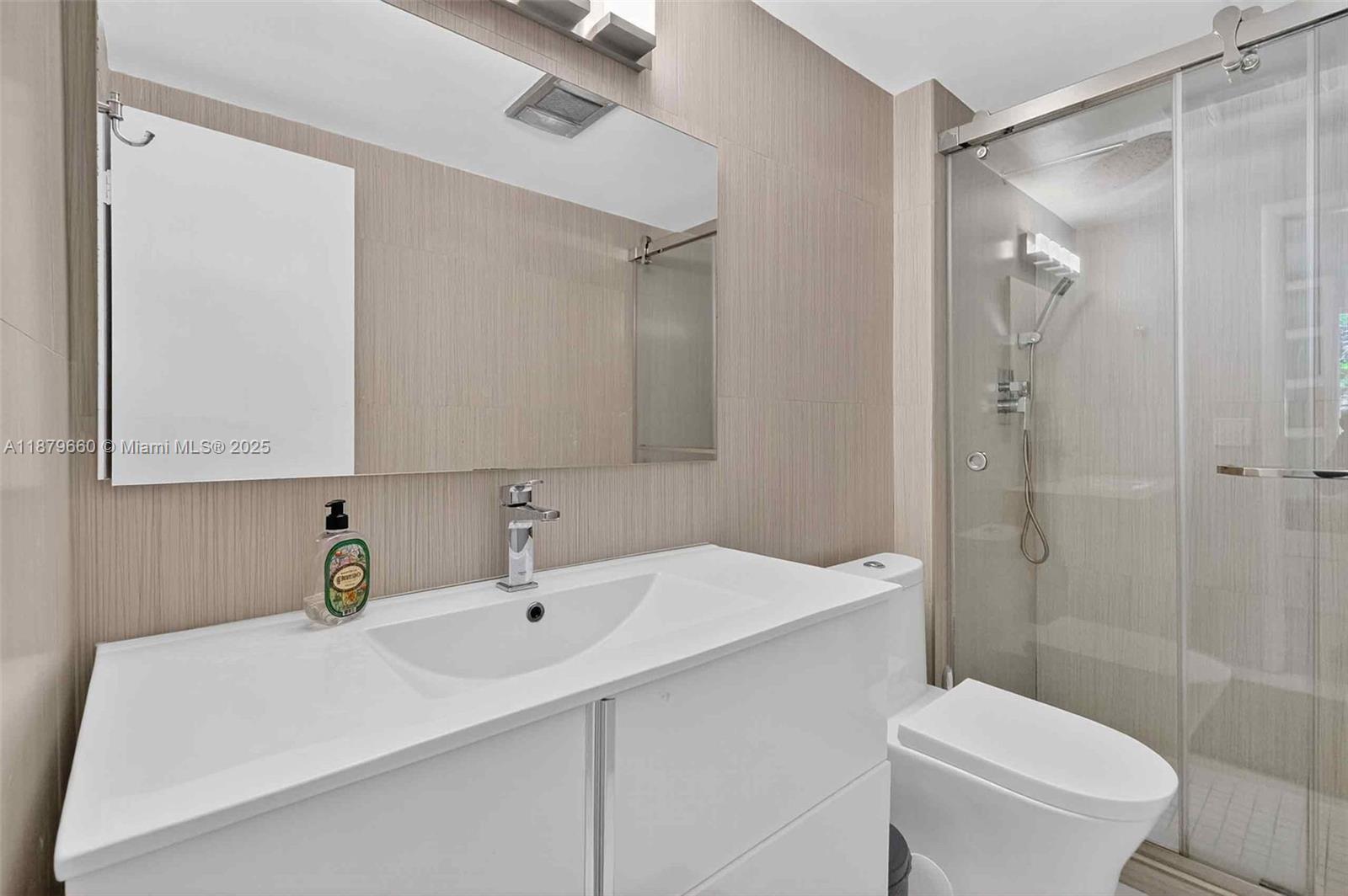 240 Galen Drive, Unit 207 Key Biscayne, FL 33149 - Photo 13 of 21 a bathroom with a sink toilet a mirror and shower