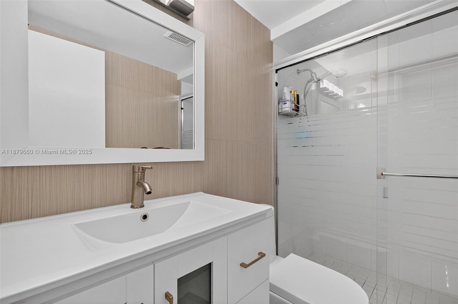 240 Galen Drive, Unit 207 Key Biscayne, FL 33149 - Photo 15 of 21 a bathroom with a sink toilet and shower