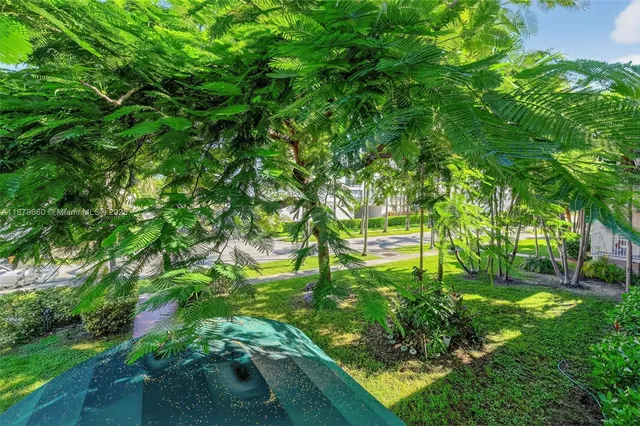 a view of a backyard with swimming pool