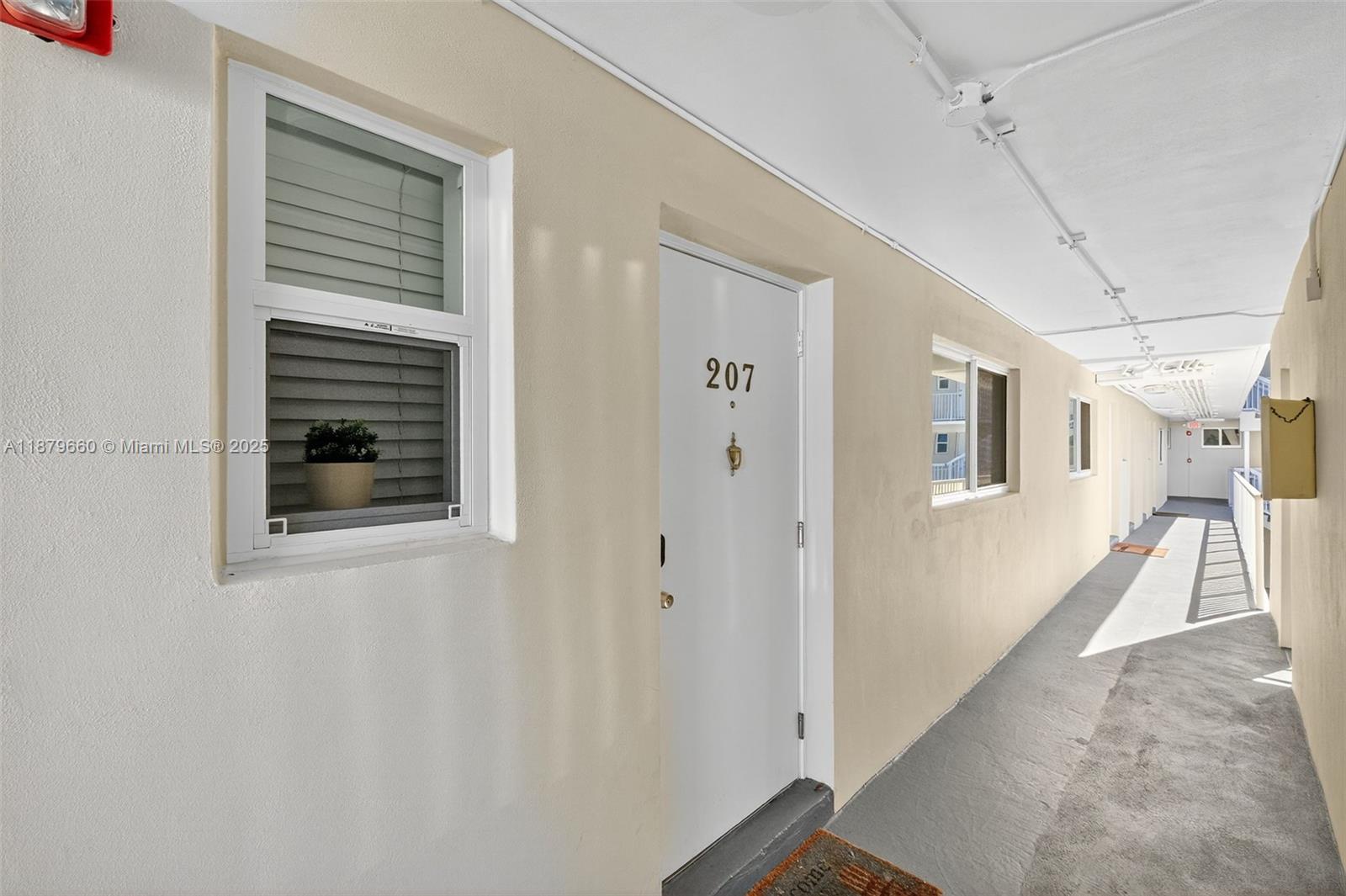 240 Galen Drive, Unit 207 Key Biscayne, FL 33149 - Photo 17 of 21 a view of a hallway with a white walls