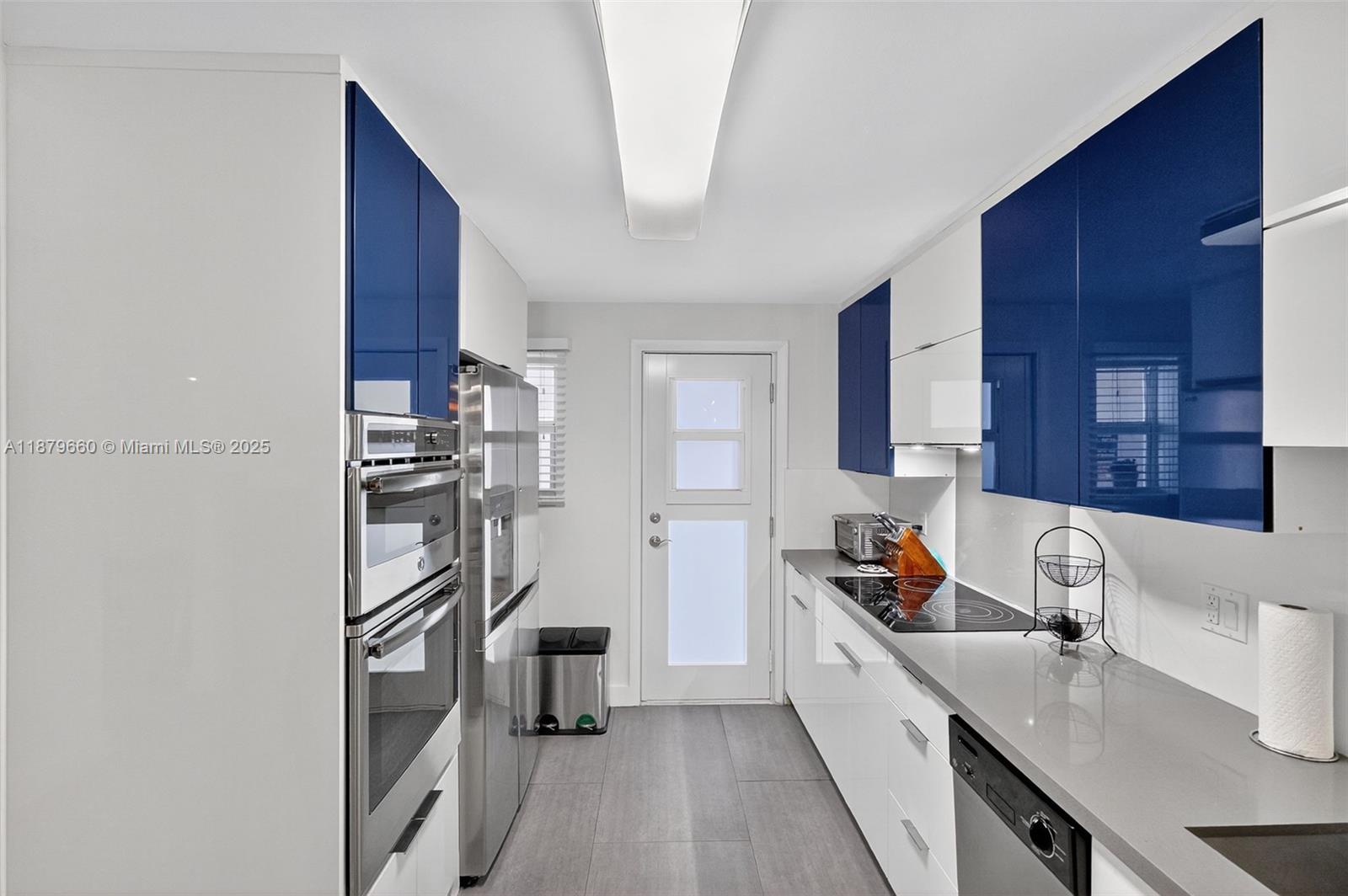 240 Galen Drive, Unit 207 Key Biscayne, FL 33149 - Photo 4 of 21 a kitchen with stainless steel appliances granite countertop a refrigerator and a sink