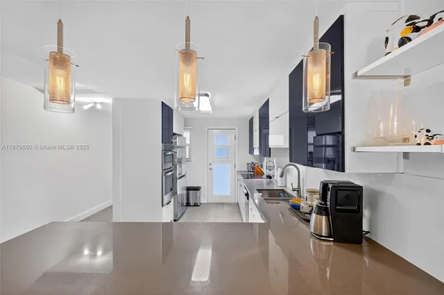 a kitchen with a table chairs and a refrigerator