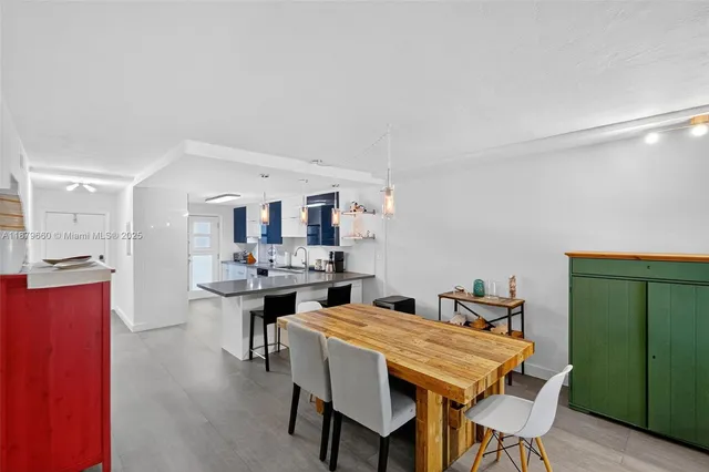 a living room with furniture and pool table