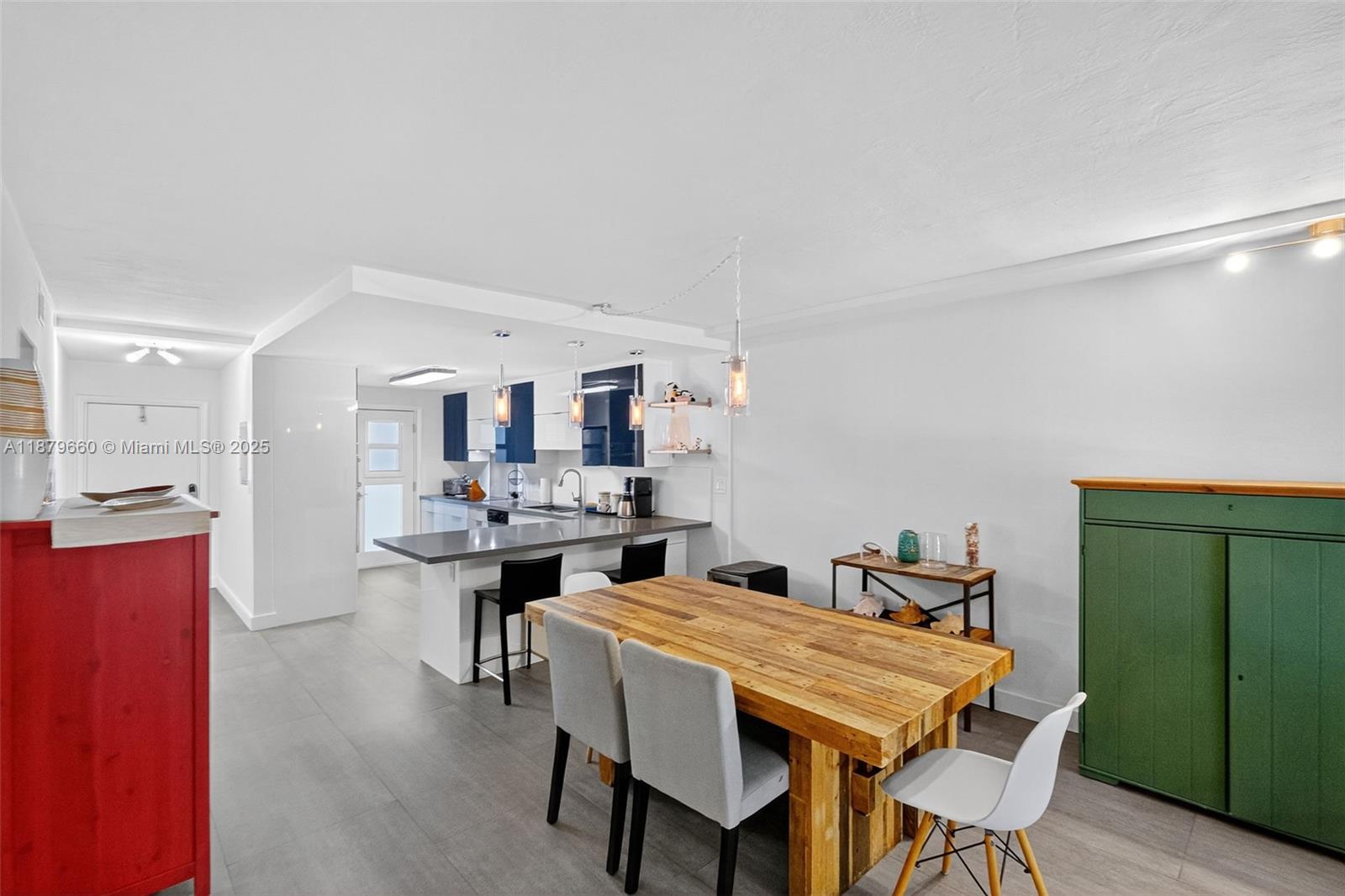 240 Galen Drive, Unit 207 Key Biscayne, FL 33149 - Photo 8 of 21 a dining hall with stainless steel appliances kitchen island a table and chairs in it