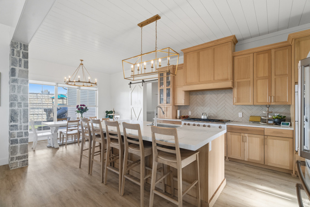 2013 South 100 West Perry, UT 84302 - Photo 13 of 49 Gourmet kitchen and dining area featuring light wood cabinetry, a large center island with seating, white countertops, and a herringbone tile backsplash