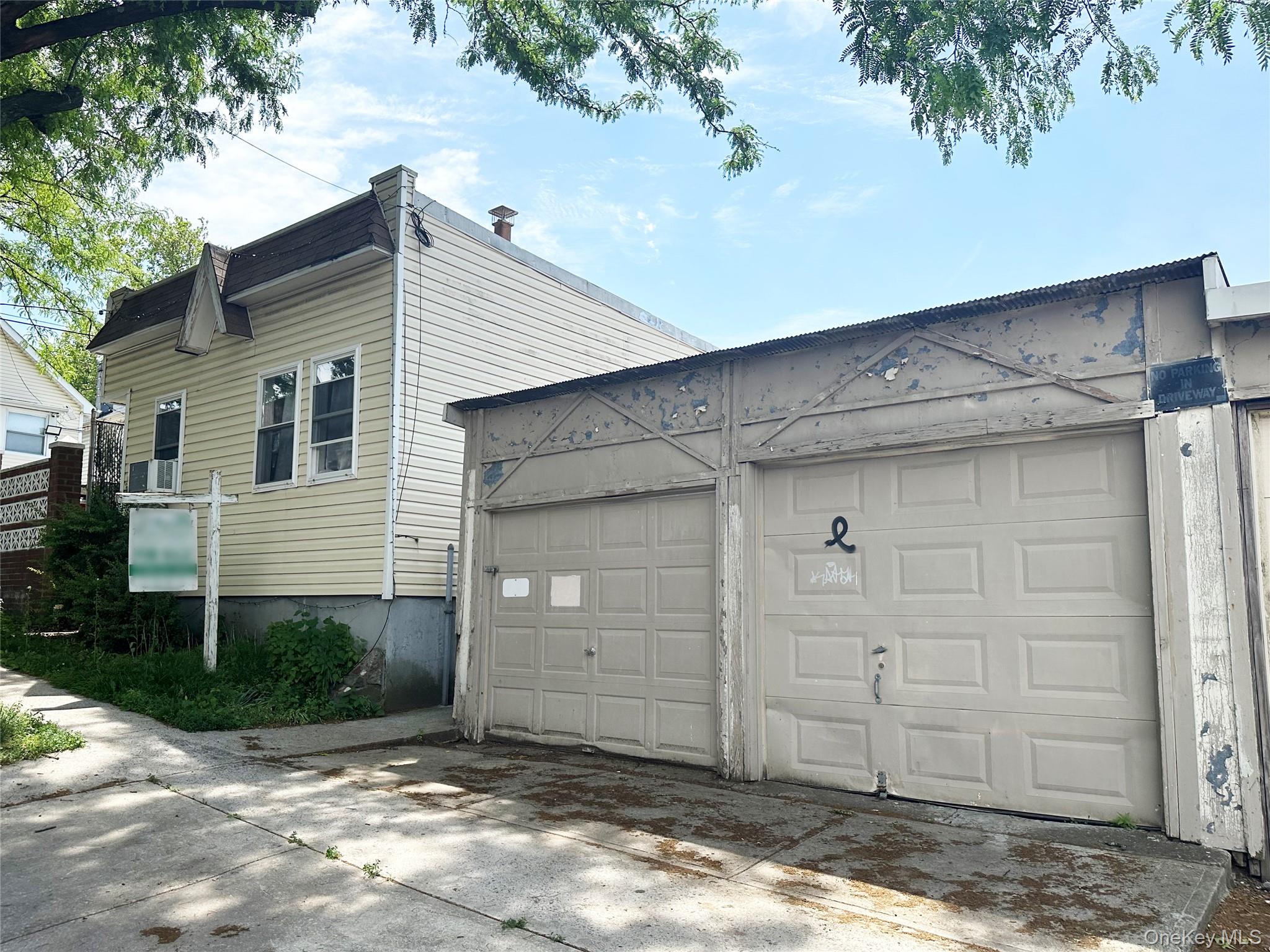 65-38 51st Road Queens, NY 11377 - Photo 4 of 6 Front of the 1-family building, and part of the 3-car garage.
