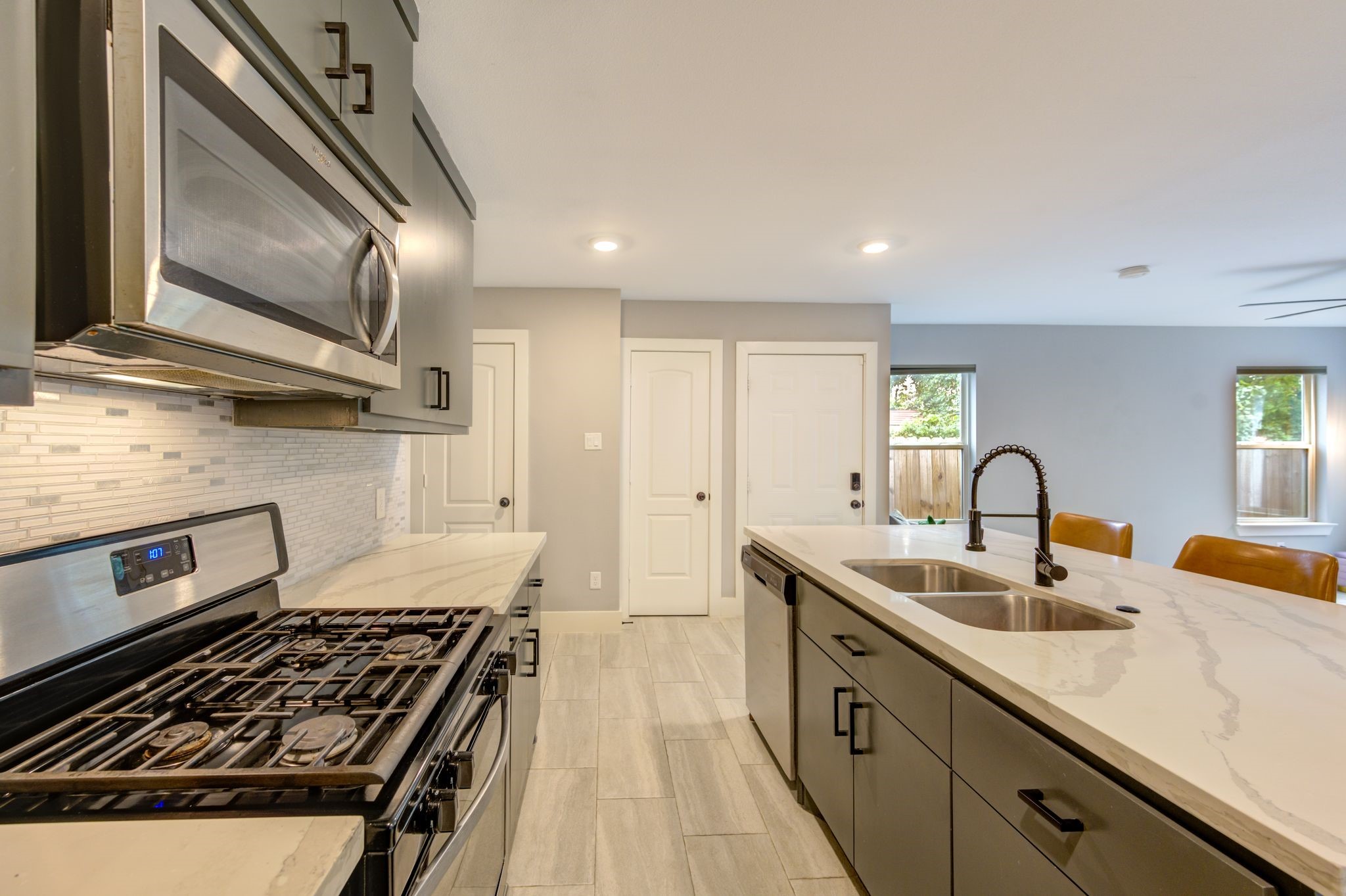 436 Owens Street Houston, TX 77029 - Photo 13 of 33 a kitchen with stainless steel appliances granite countertop a sink stove and cabinets